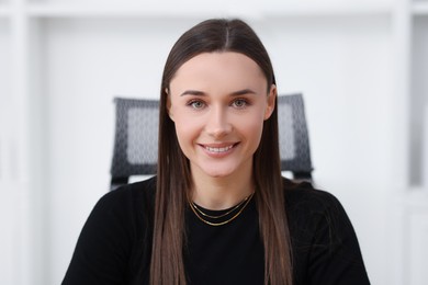 Photo of Portrait of happy beautiful businesswoman in office