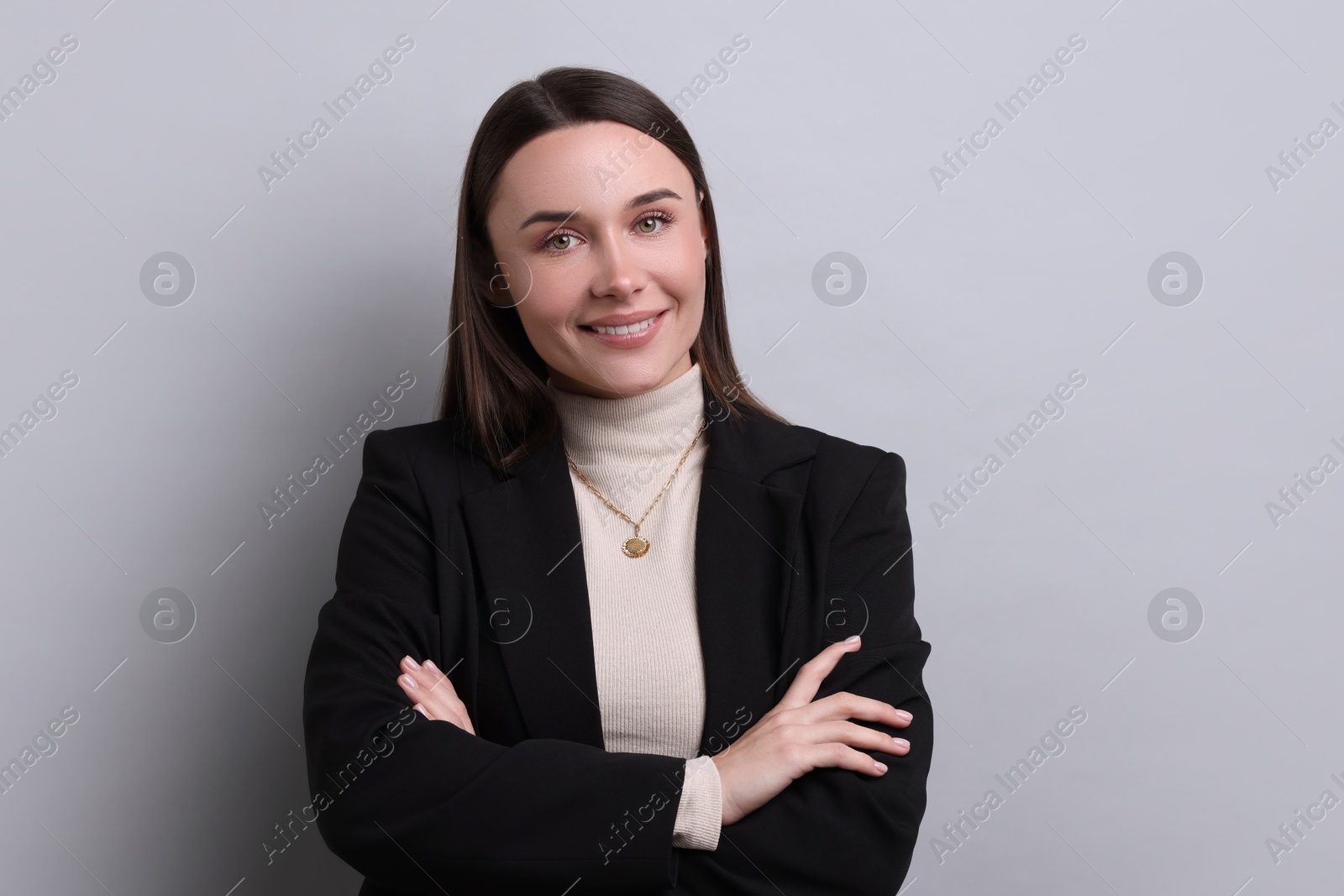 Photo of Portrait of businesswoman on light grey background