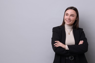 Photo of Portrait of businesswoman on light grey background, space for text