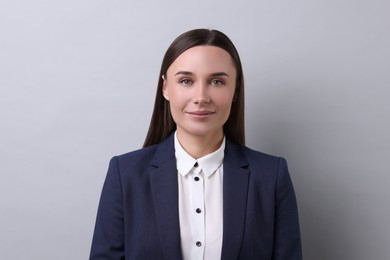 Photo of Portrait of businesswoman on light grey background