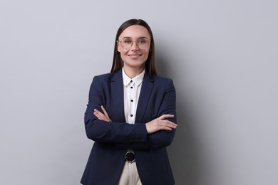 Photo of Portrait of businesswoman in glasses on light grey background