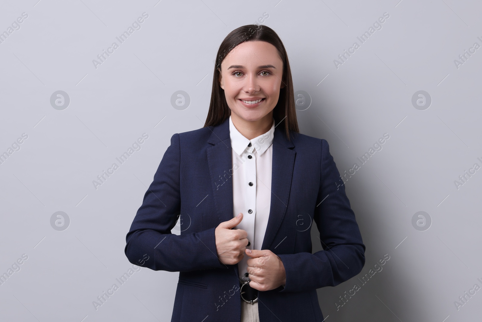 Photo of Portrait of businesswoman on light grey background