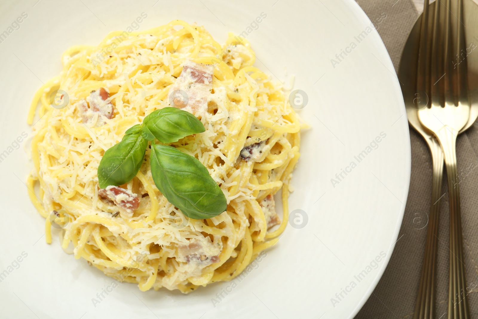 Photo of Delicious pasta Carbonara served on table, top view