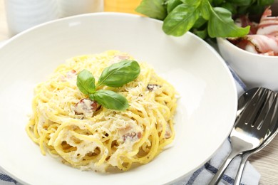 Photo of Delicious pasta Carbonara served on table, closeup