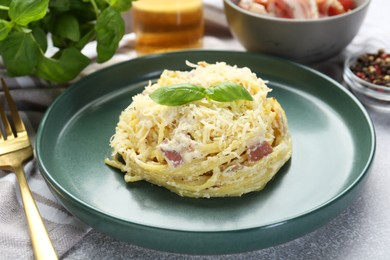 Photo of Delicious pasta Carbonara served on gray table, closeup