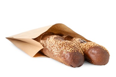 Photo of Fresh baguettes with sesame in paper bag isolated on white