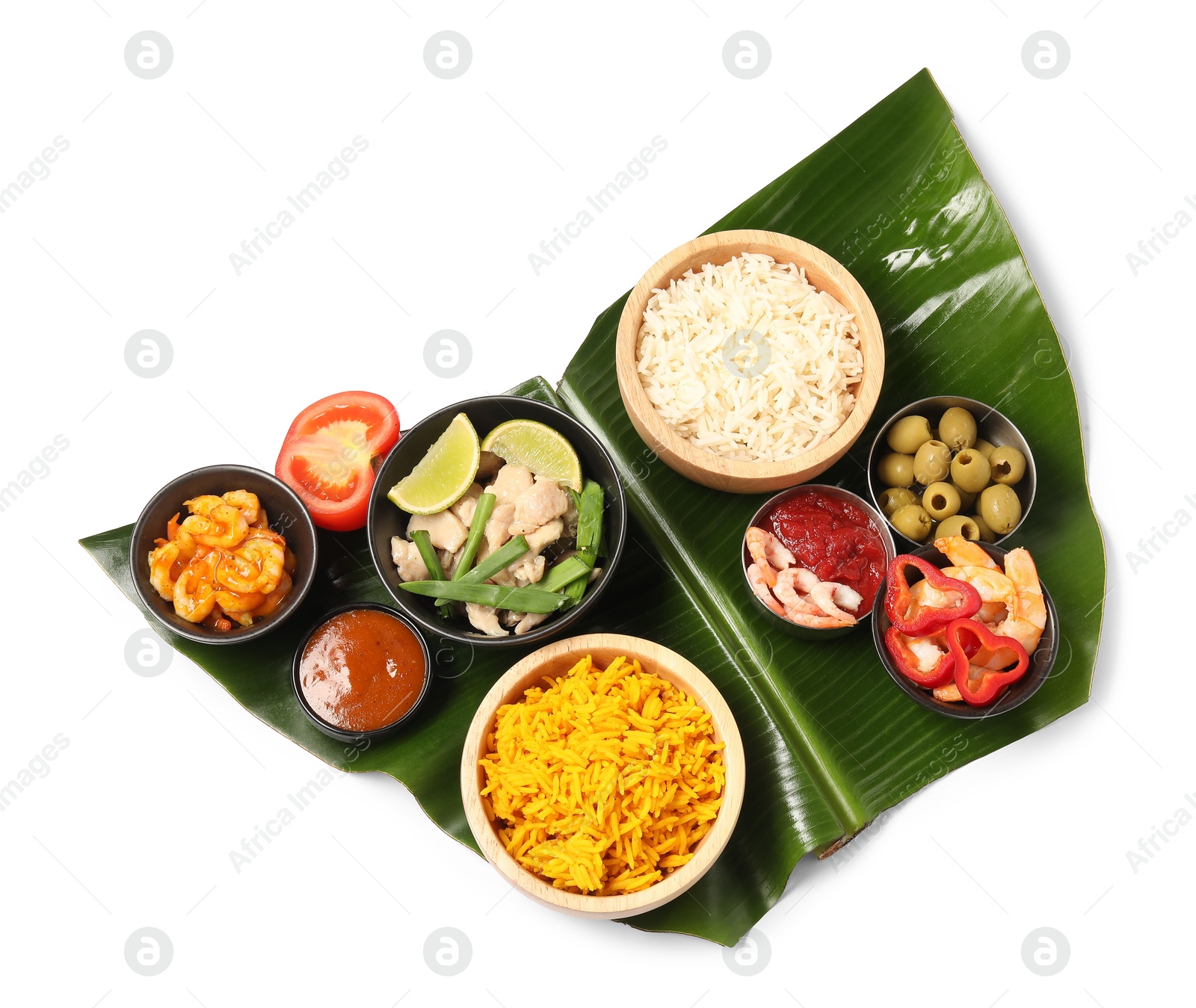 Photo of Piece of banana leaf with different food and sauce isolated on white, top view. Healthy eco serving