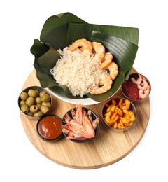 Photo of Cut banana leaves with different food and sauce isolated on white, above view