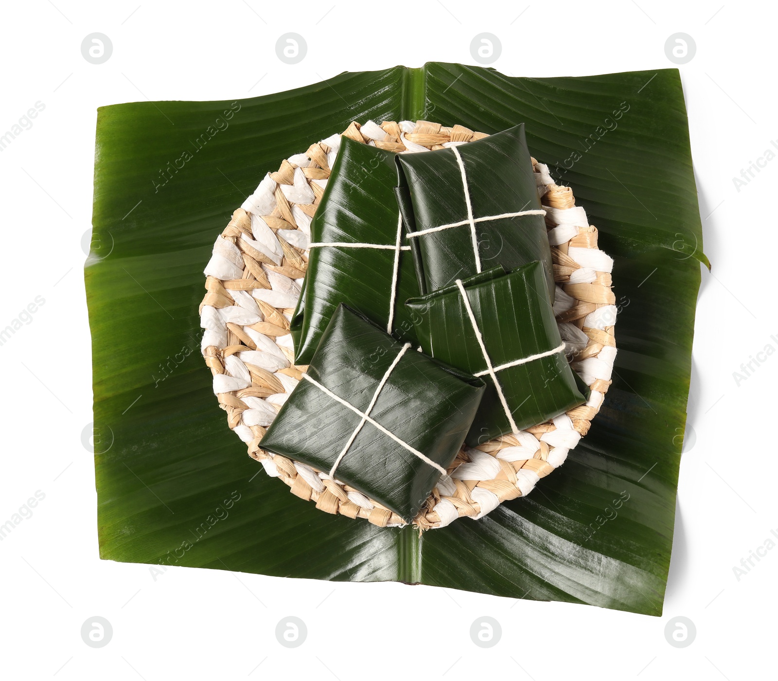 Photo of Cut banana leaves with food isolated on white, top view. Healthy eco serving