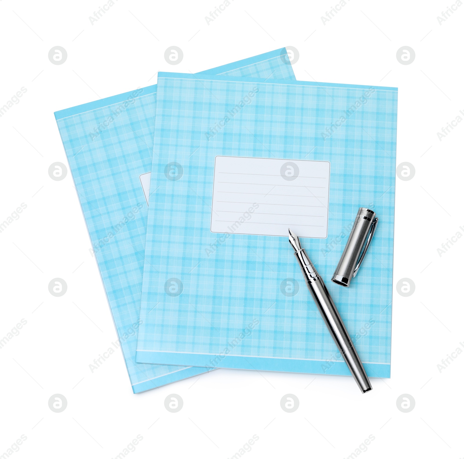 Photo of Copybooks and pen isolated on white, top view. School stationery