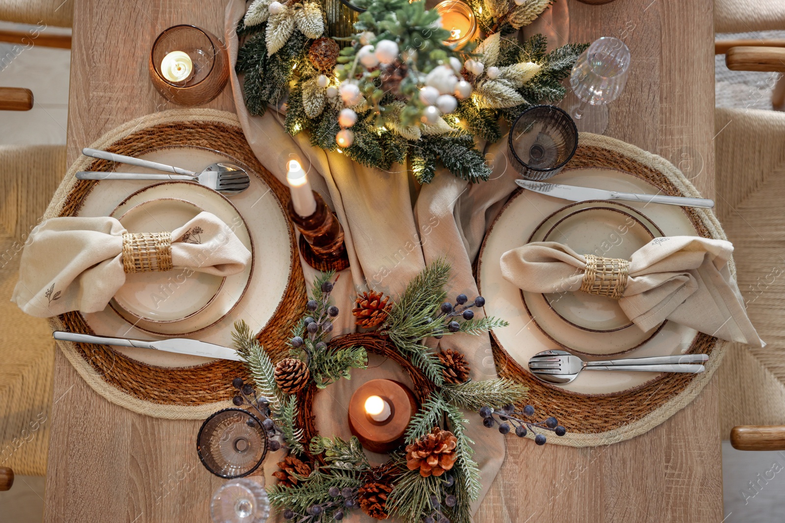 Photo of Christmas celebration. Festive table setting with dishware, glasses and decor in room, top view