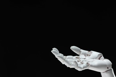 Photo of Artificial intelligence. Robot hand gesturing on black background, space for text