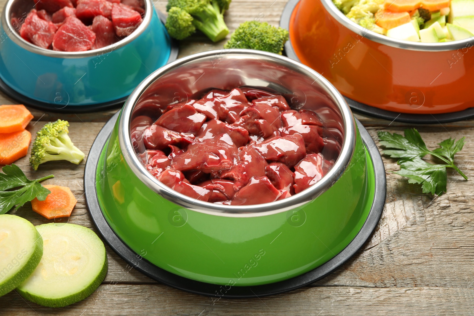 Photo of Pet food. Natural products on wooden table, closeup