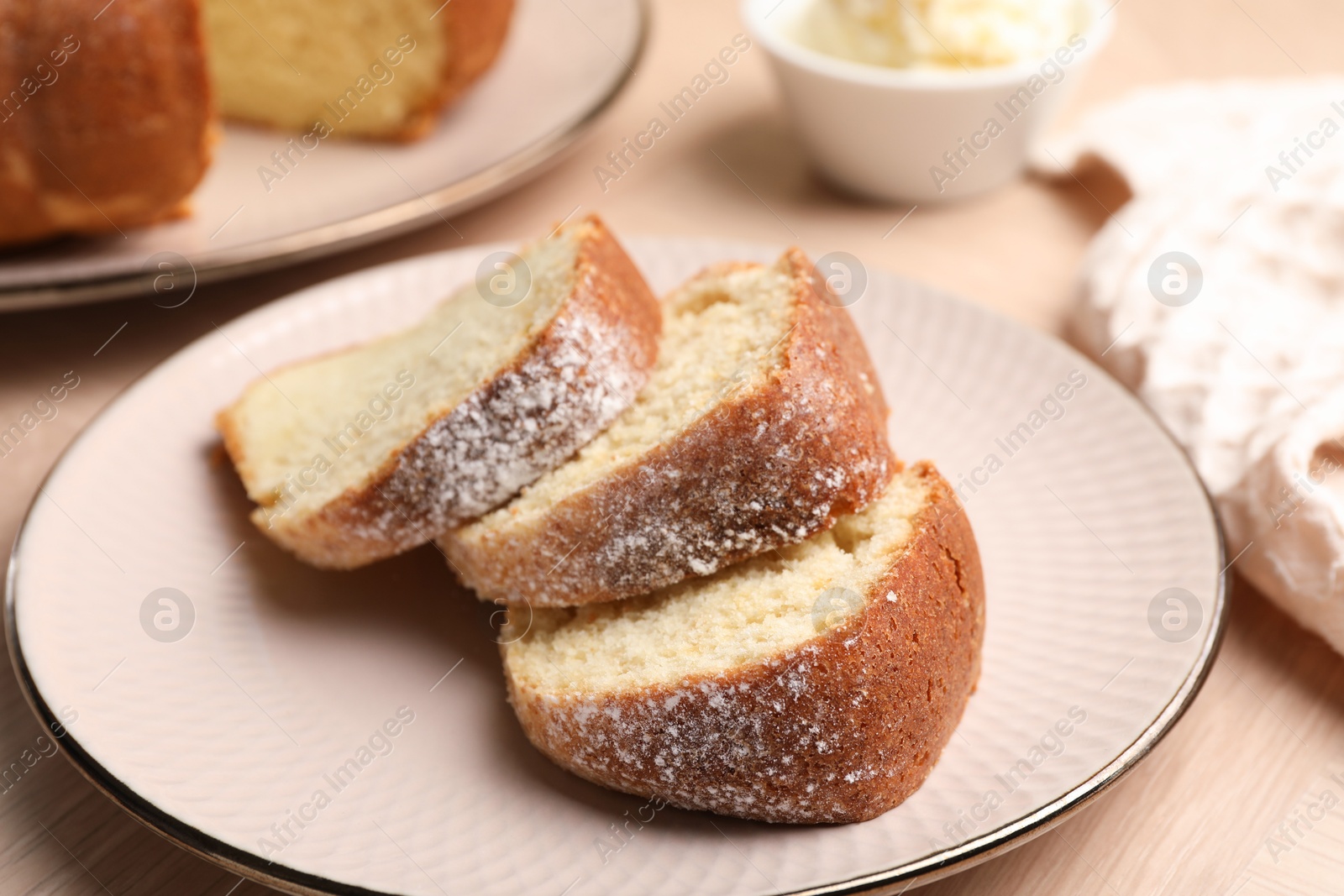 Photo of Pieces of freshly baked sponge cake on table, closeup