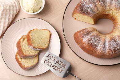 Photo of Pieces of freshly baked sponge cake, server and ice cream on wooden table, top view