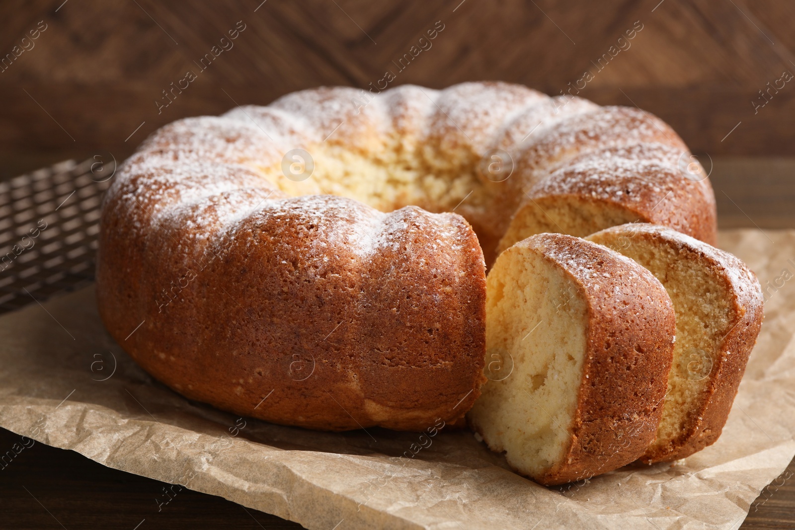 Photo of Freshly baked sponge cake on wooden table, closeup