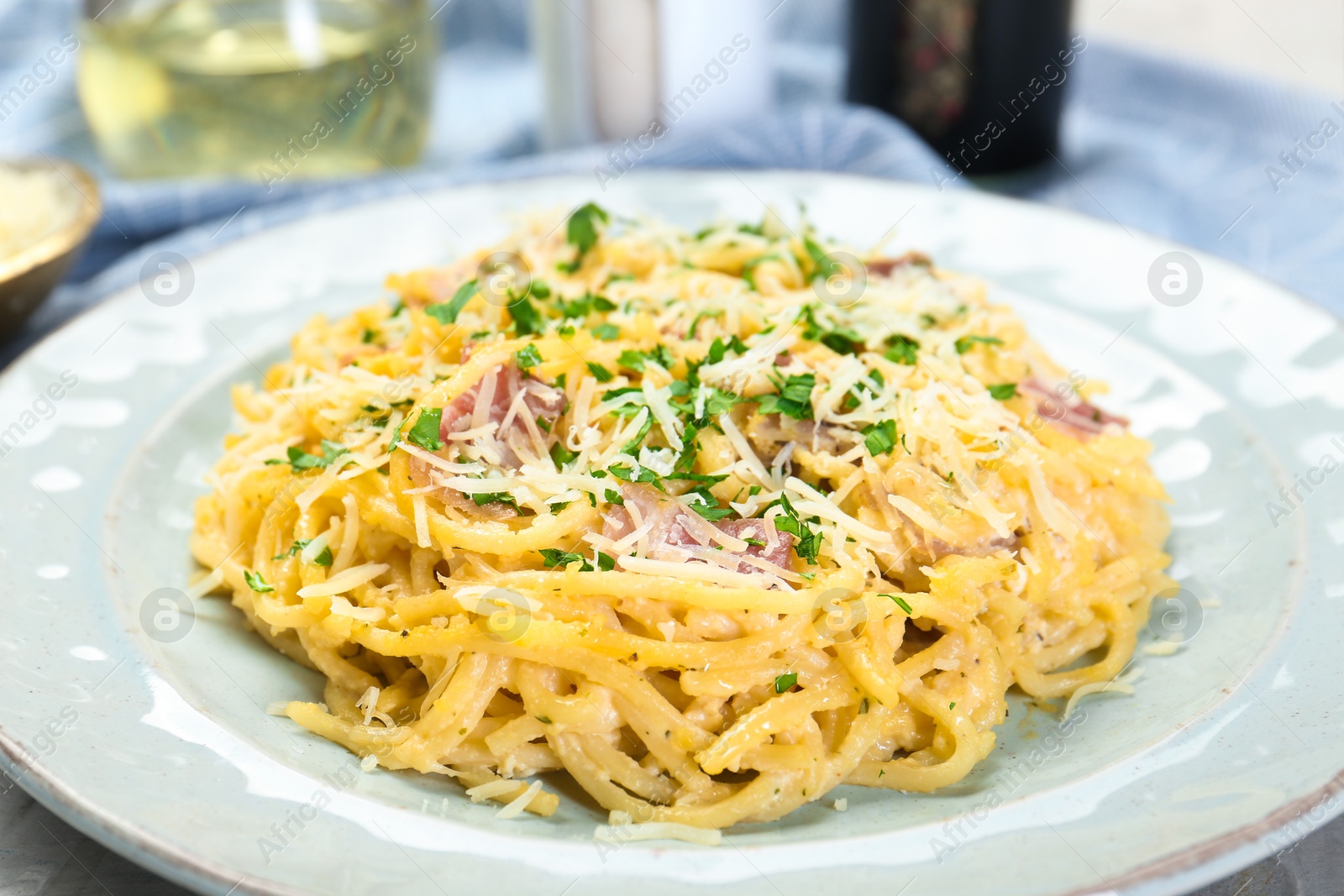 Photo of Delicious pasta Carbonara with bacon on table, closeup