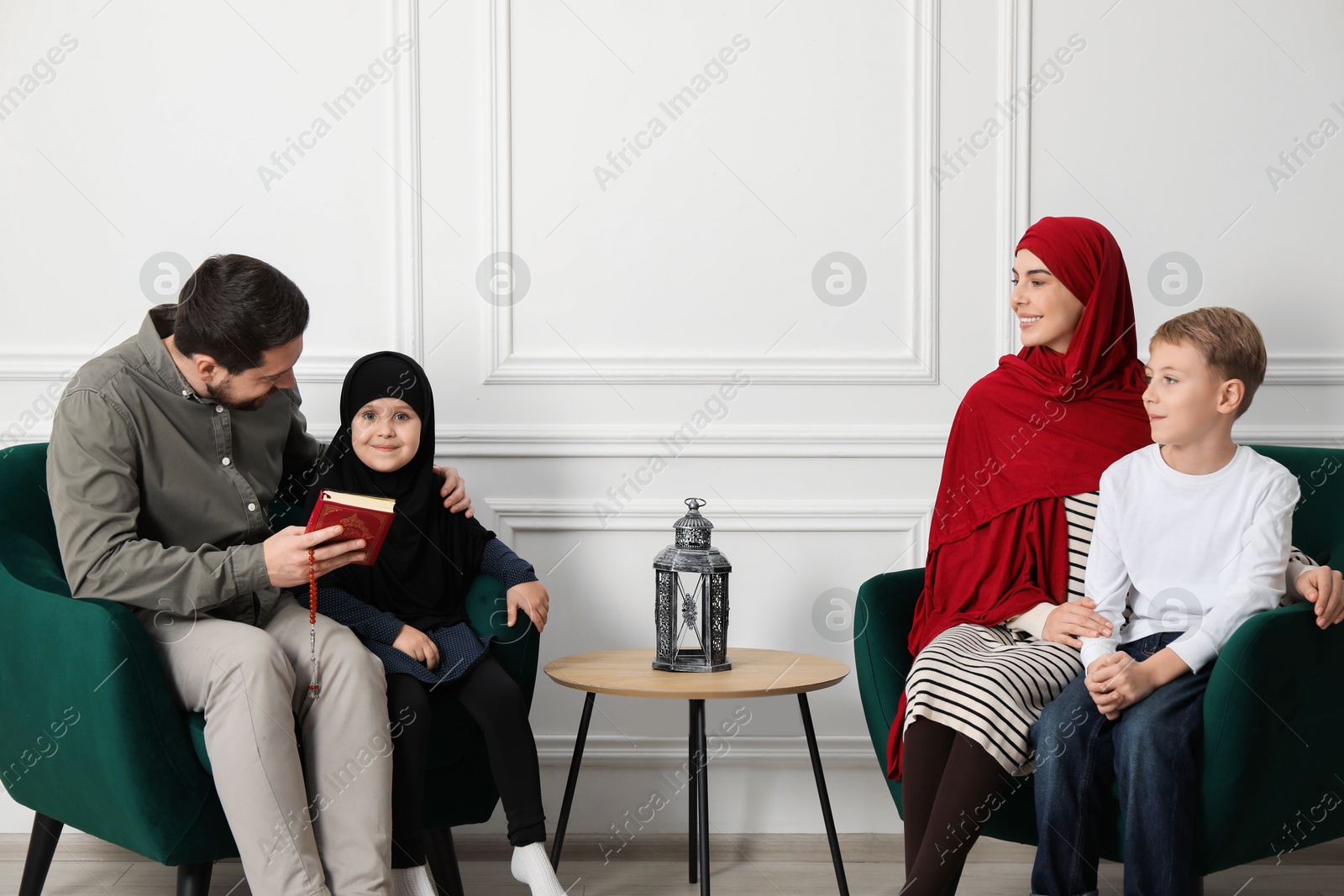 Photo of Happy Muslim family spending time together at home