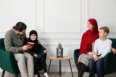 Photo of Happy Muslim family spending time together at home