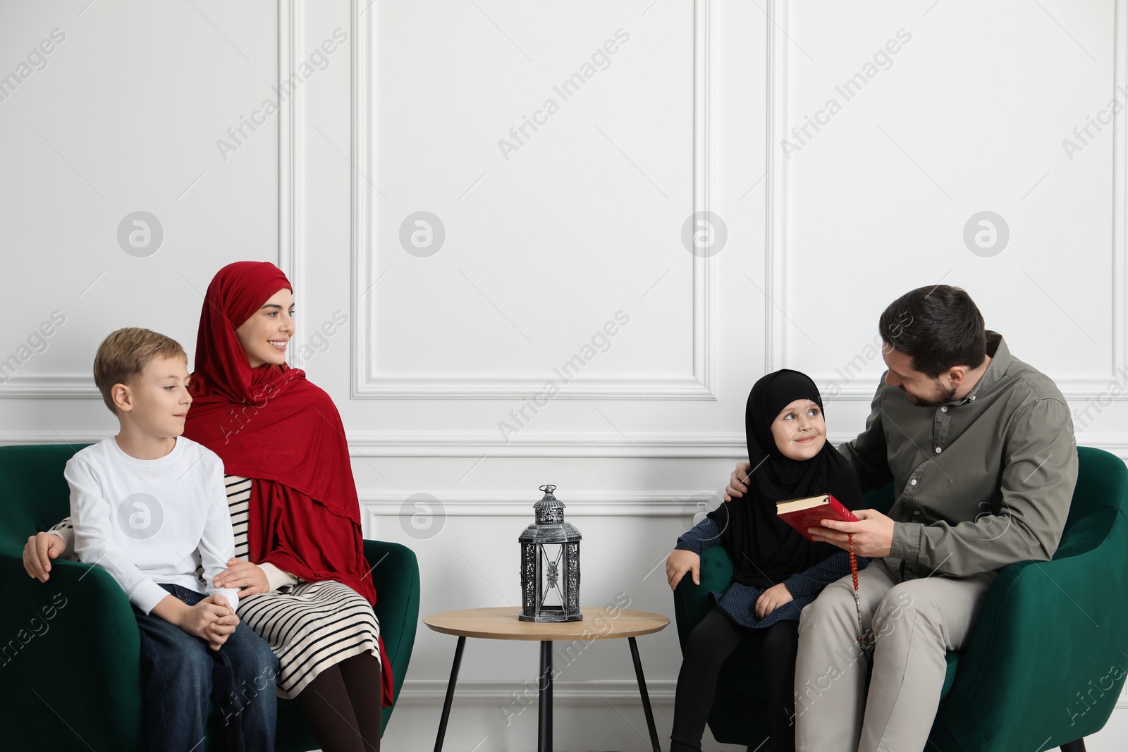 Photo of Happy Muslim family spending time together at home