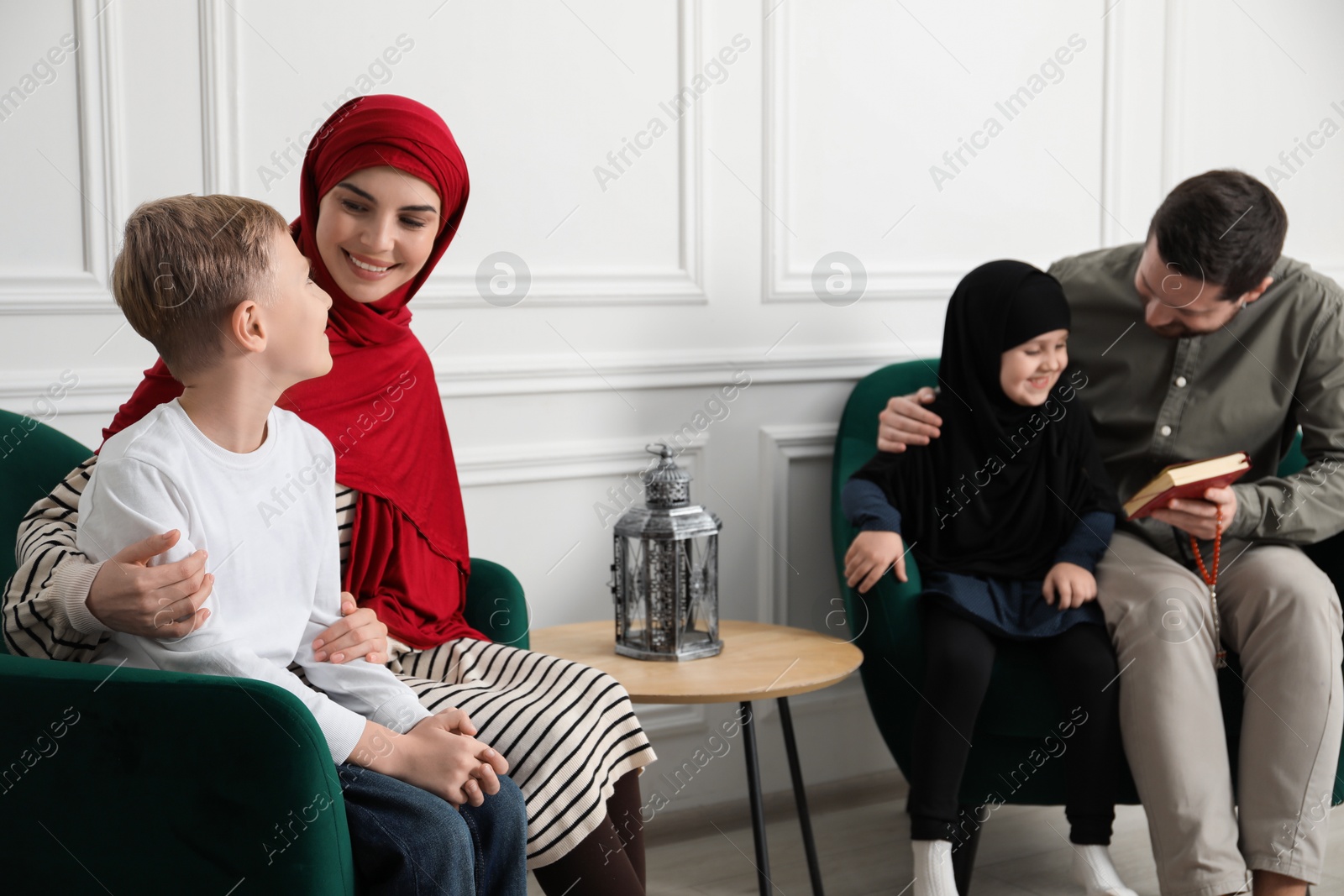 Photo of Happy Muslim family spending time together at home