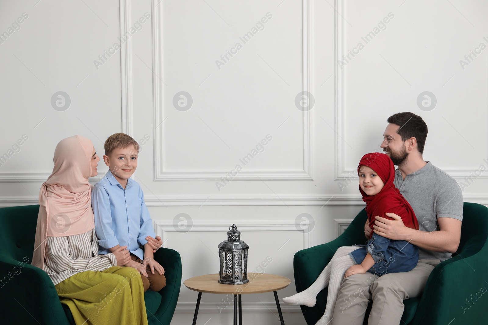 Photo of Happy Muslim family spending time together at home