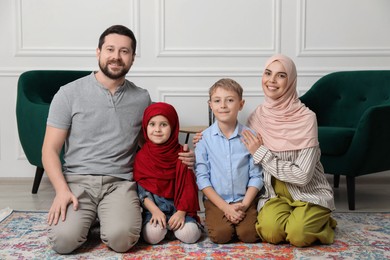 Photo of Happy Muslim family spending time together at home