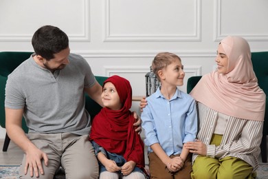 Photo of Happy Muslim family spending time together at home