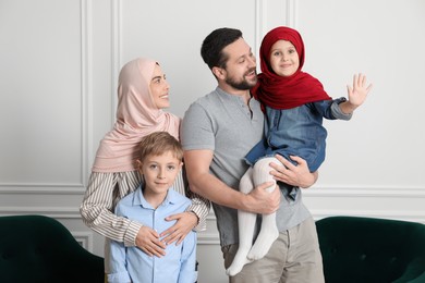 Happy Muslim family spending time together at home