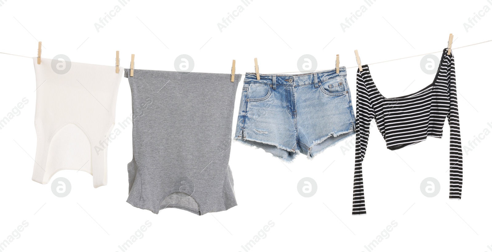 Photo of Different clothes drying on laundry line against white background