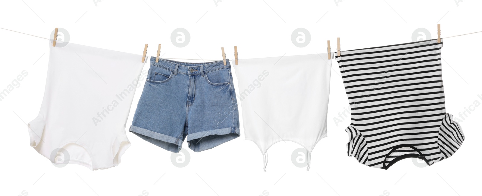 Photo of Different clothes drying on laundry line against white background