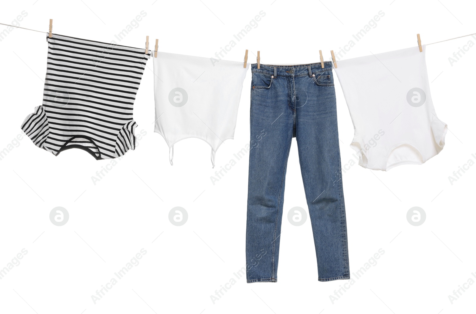 Photo of Different clothes drying on laundry line against white background