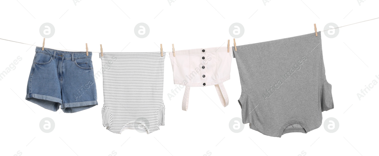 Photo of Different clothes drying on laundry line against white background