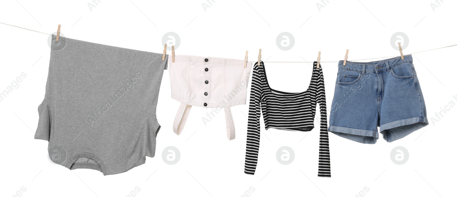 Photo of Different clothes drying on laundry line against white background