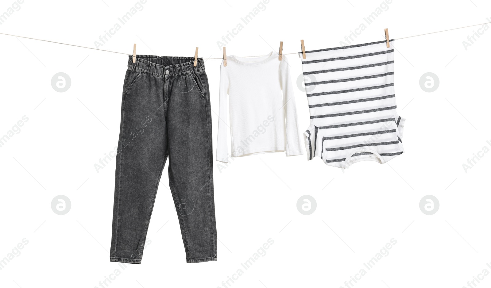 Photo of Different clothes drying on laundry line against white background