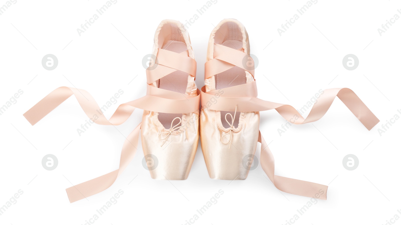 Photo of Pair of beautiful beige pointe shoes isolated on white, top view