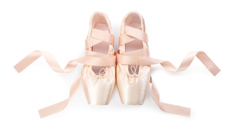 Photo of Pair of beautiful beige pointe shoes isolated on white, top view