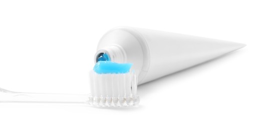 Photo of Toothbrush with toothpaste and tube isolated on white