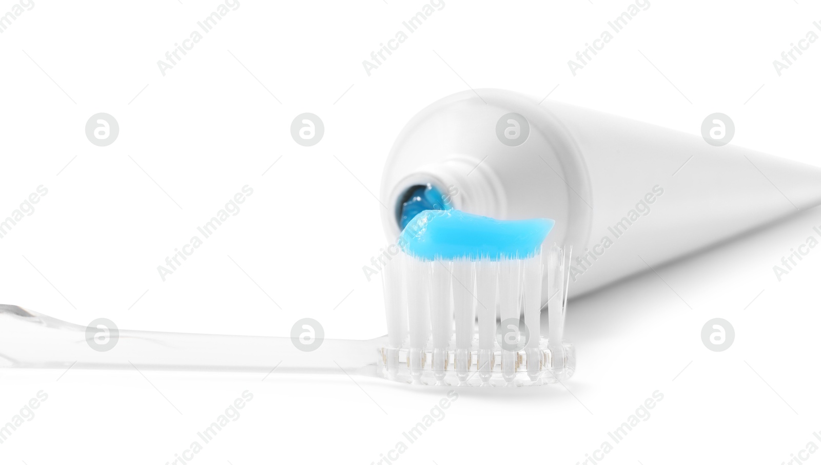 Photo of Toothbrush with toothpaste and tube isolated on white