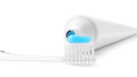 Photo of Toothbrush with toothpaste and tube isolated on white