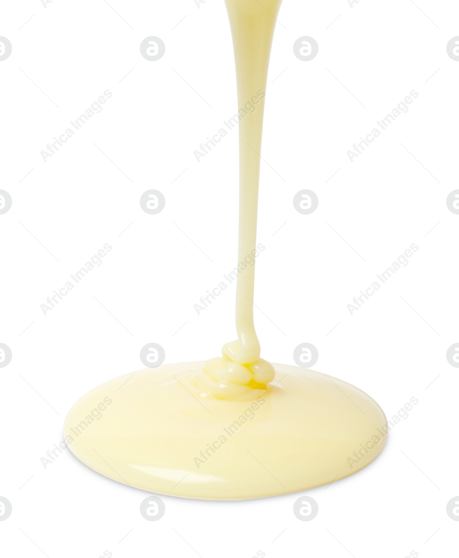 Photo of Pouring delicious condensed milk isolated on white