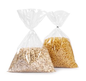 Photo of Plastic bags with pasta and oat flakes isolated on white