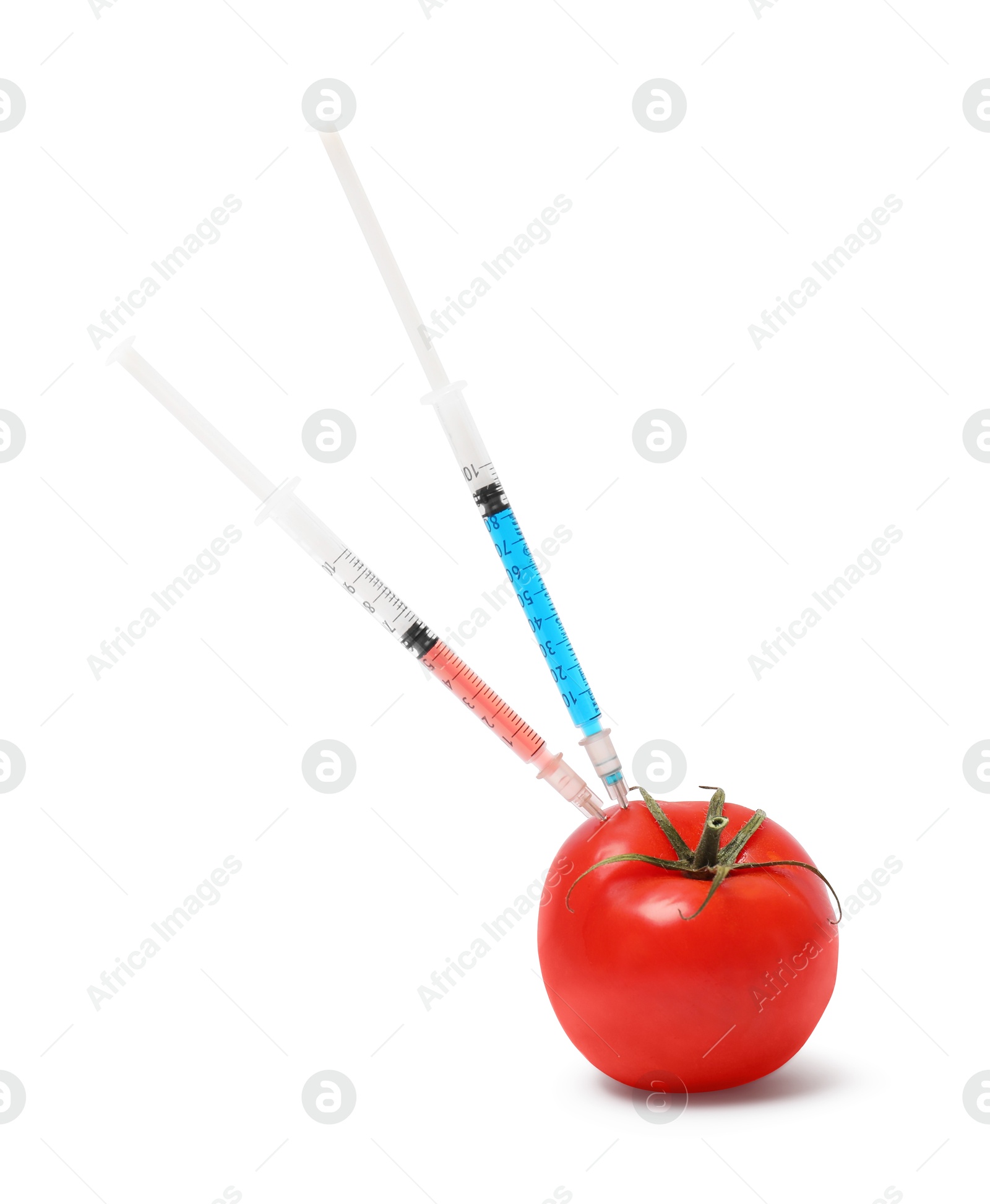 Photo of GMO concept. Fresh tomato and syringes isolated on white