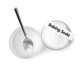 Glass of water and baking soda on white background, top view