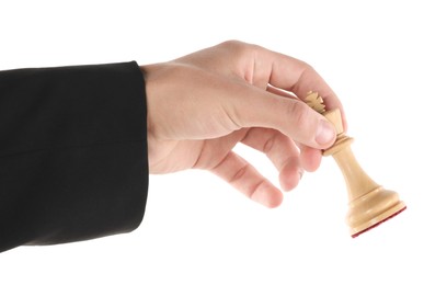 Photo of Man holding chess king on white background, closeup. Competition concept