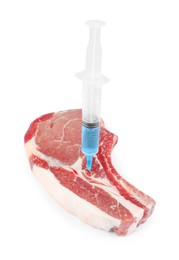 Photo of GMO concept. Pork steak and syringe isolated on white