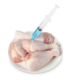 Photo of GMO concept. Chicken drumsticks and syringe isolated on white