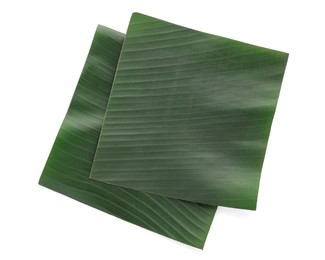 Photo of Pieces of banana leaves isolated on white, top view. Traditional meal serving