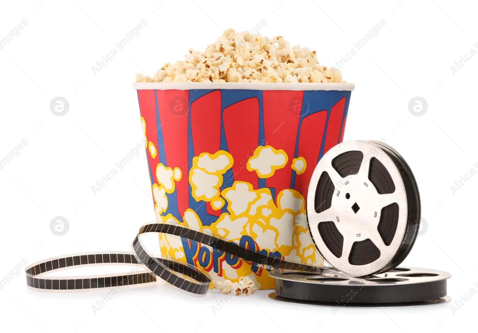 Photo of Tasty popcorn and film reels isolated on white