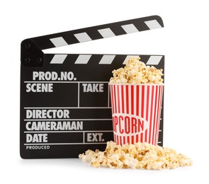 Photo of Tasty popcorn and movie clapper isolated on white